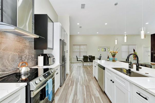Dining room, Interior, Kitchen, Pendant Lights, Recessed Lighting, Stainless Steel Appliances, Wood Texture Flooring