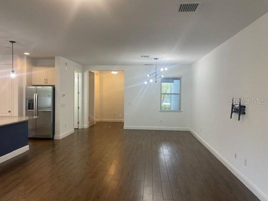 Empty room, Interior, Kitchen, Pendant Lights, Recessed Lighting, Stainless Steel Appliances, Wood Texture Flooring