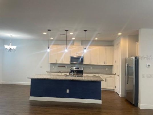 Chandelier, Interior, Kitchen, Pendant Lights, Recessed Lighting, Stainless Steel Appliances, Wood Texture Flooring
