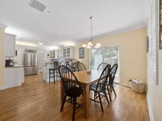 Chandelier, Dining room, Interior, Kitchen, Pendant Lights, Stainless Steel Appliances, Wood Texture Flooring