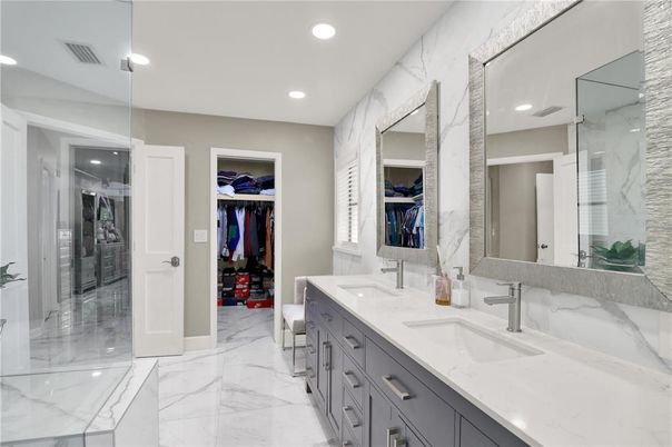 Bathroom, Dual Sink Vanities, Glass Shower, Interior, Marble, Marble Walls, Recessed Lighting, Walk-in Closets