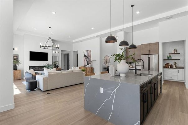 Fireplace, Interior, Kitchen, Living room, Pendant Lights, Recessed Lighting, Stainless Steel Appliances, Wood Texture Flooring