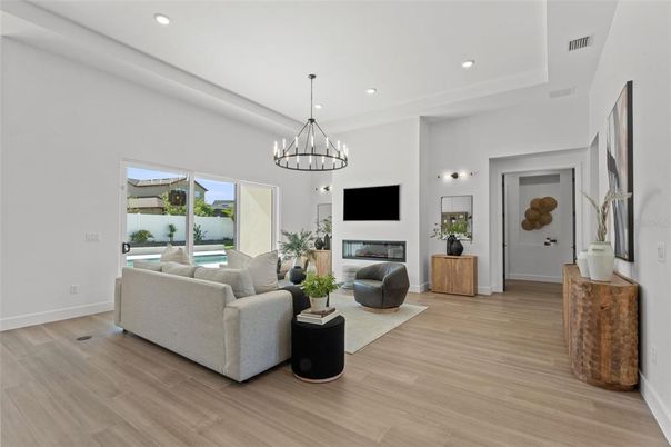 Chandelier, Fireplace, Interior, Living room, Pendant Lights, Recessed Lighting, Wood Texture Flooring