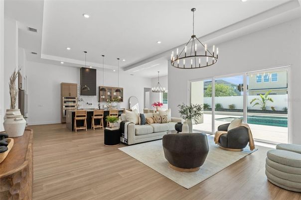 Chandelier, Interior, Kitchen, Living room, Pendant Lights, Recessed Lighting, Stainless Steel Appliances, Wood Texture Flooring