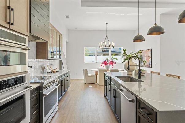 Chandelier, Dining room, Interior, Kitchen, Pendant Lights, Stainless Steel Appliances, Wood Texture Flooring