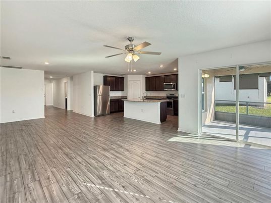 Empty room, Interior, Kitchen, Recessed Lighting, Stainless Steel Appliances, Wood Texture Flooring