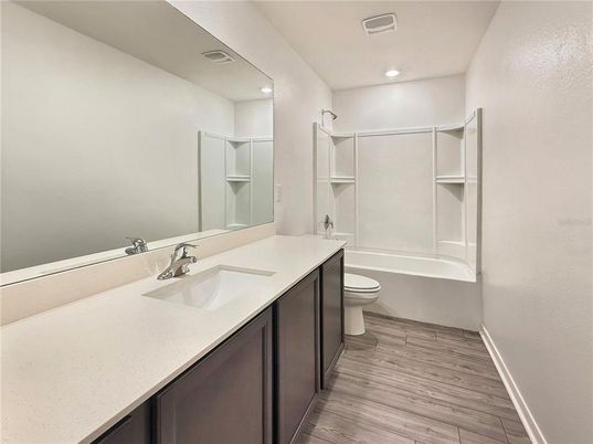 Bathroom, Dual Sink Vanities, Interior, Recessed Lighting, Walk-in Closets, Wood Texture Flooring