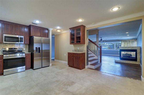 Fireplace, Interior, Kitchen, Recessed Lighting, Stainless Steel Appliances, Wood Texture Flooring