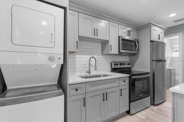Interior, Kitchen, Recessed Lighting, Washer, Wood Texture Flooring