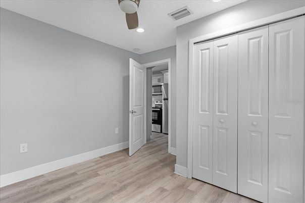 Empty room, Interior, Kitchen, Recessed Lighting, Stainless Steel Appliances, Wood Texture Flooring