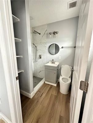 Bathroom, Glass Shower, Interior, Marble Walls, Wood Texture Flooring