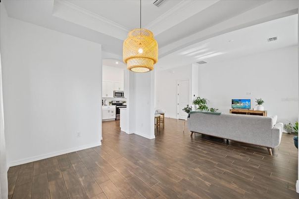 Chandelier, Interior, Kitchen, Living room, Pendant Lights, Recessed Lighting, Stainless Steel Appliances, Wood Texture Flooring