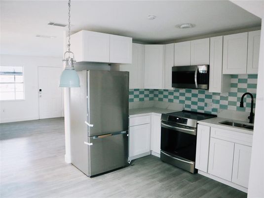 Interior, Kitchen, Pendant Lights, Recessed Lighting, Stainless Steel Appliances, Wood Texture Flooring