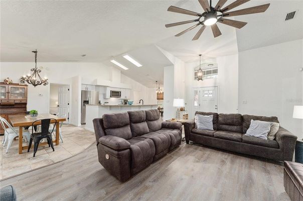 Chandelier, Dining room, Interior, Kitchen, Living room, Pendant Lights, Stainless Steel Appliances, Wood Texture Flooring