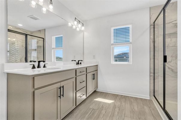 Bathroom, Dual Sink Vanities, Glass Shower, Interior, Marble Walls, Recessed Lighting, Wood Texture Flooring