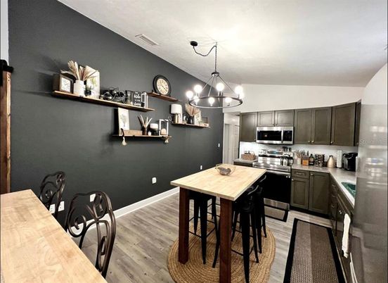 Chandelier, Dining room, Interior, Kitchen, Stainless Steel Appliances, Wood Texture Flooring