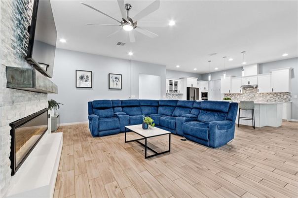 Fireplace, Interior, Kitchen, Living room, Pendant Lights, Recessed Lighting, Stainless Steel Appliances, Stone Walls, Wood Texture Flooring