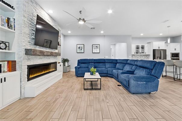 Fireplace, Interior, Kitchen, Living room, Pendant Lights, Recessed Lighting, Stainless Steel Appliances, Stone Walls, Wood Texture Flooring