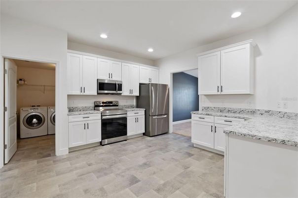Interior, Kitchen, Recessed Lighting, Stainless Steel Appliances, Washer, Wood Texture Flooring