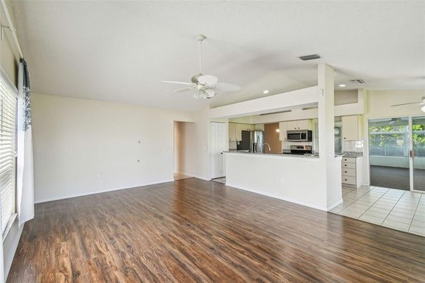 Empty room, Interior, Kitchen, Recessed Lighting, Stainless Steel Appliances, Wood Texture Flooring