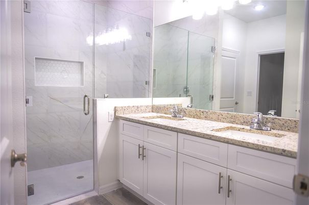Bathroom, Dual Sink Vanities, Glass Shower, Interior, Marble Walls, Recessed Lighting