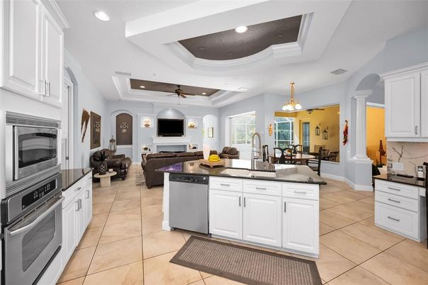 Chandelier, Dining room, Fireplace, Interior, Kitchen, Living room, Pendant Lights, Recessed Lighting, Stainless Steel Appliances