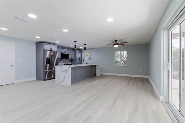Empty room, Interior, Kitchen, Recessed Lighting, Stainless Steel Appliances, Wood Texture Flooring