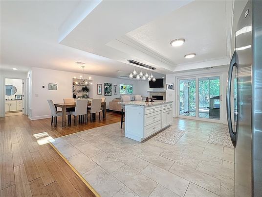 Chandelier, Dining room, Interior, Kitchen, Pendant Lights, Recessed Lighting, Stainless Steel Appliances, Wood Texture Flooring