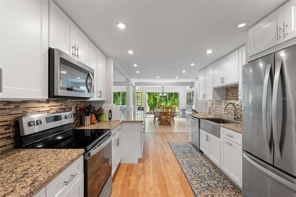 Chandelier, Dining room, Interior, Kitchen, Pendant Lights, Recessed Lighting, Stainless Steel Appliances, Wood Texture Flooring