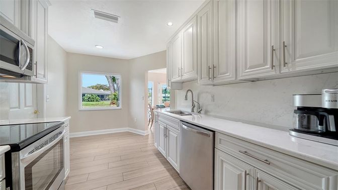 Interior, Kitchen, Marble Walls, Recessed Lighting, Stainless Steel Appliances, Wood Texture Flooring
