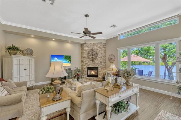 Fireplace, Interior, Living room, Recessed Lighting, Stone Walls, Water, Wood Texture Flooring