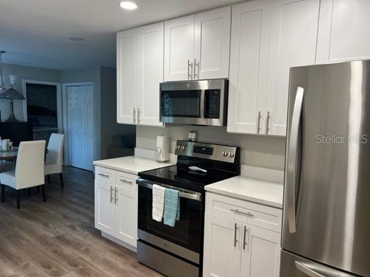 Dining room, Interior, Kitchen, Pendant Lights, Recessed Lighting, Stainless Steel Appliances, Wood Texture Flooring