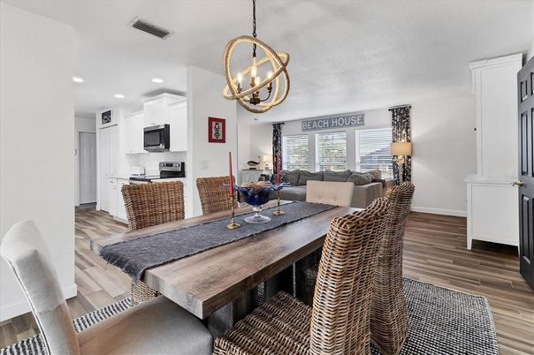Chandelier, Dining room, Interior, Kitchen, Living room, Pendant Lights, Recessed Lighting, Stainless Steel Appliances, Wood Texture Flooring