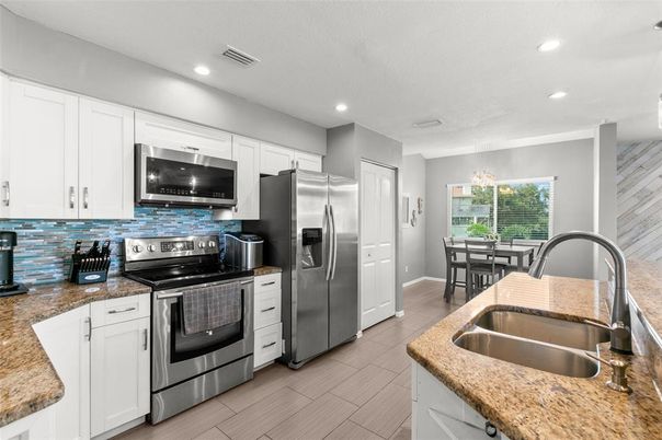 Dining room, Interior, Kitchen, Recessed Lighting, Stainless Steel Appliances, Wood Texture Flooring