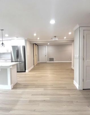 Empty room, Interior, Kitchen, Pendant Lights, Recessed Lighting, Stainless Steel Appliances, Wood Texture Flooring