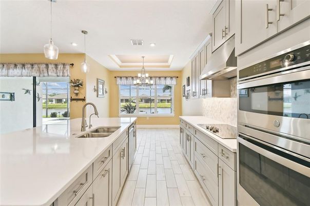 Chandelier, Interior, Kitchen, Pendant Lights, Recessed Lighting, Stainless Steel Appliances, Wood Texture Flooring