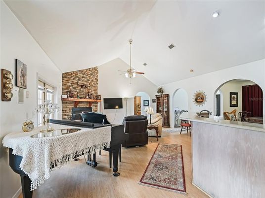 Fireplace, Interior, Living room, Piano, Recessed Lighting, Stone Walls, Wood Texture Flooring
