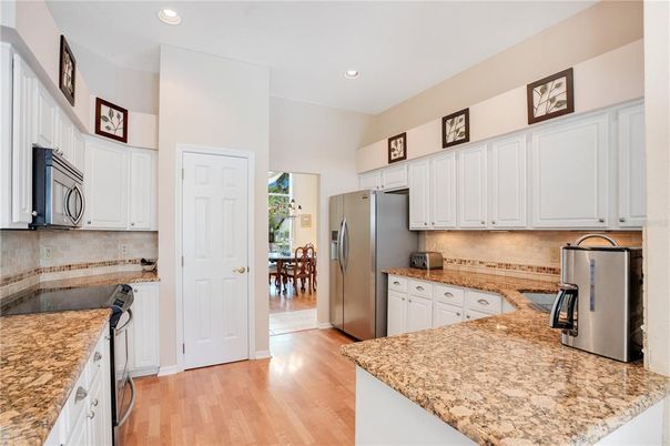 Dining room, Interior, Kitchen, Recessed Lighting, Stainless Steel Appliances, Wood Texture Flooring