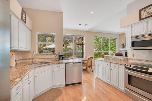 Chandelier, Dining room, Interior, Kitchen, Recessed Lighting, Stainless Steel Appliances, Wood Texture Flooring