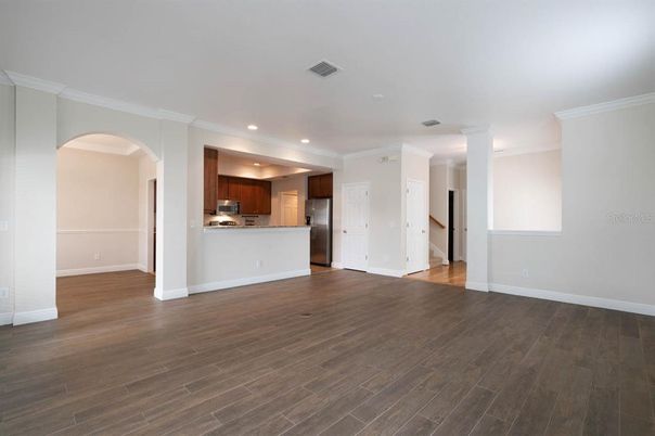 Empty room, Interior, Kitchen, Recessed Lighting, Stainless Steel Appliances, Wood Texture Flooring