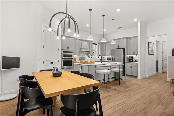 Dining room, Interior, Kitchen, Pendant Lights, Recessed Lighting, Stainless Steel Appliances, Wood Texture Flooring