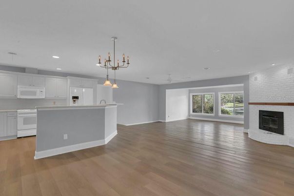 Empty room, Fireplace, Interior, Kitchen, Pendant Lights, Recessed Lighting, Wood Texture Flooring