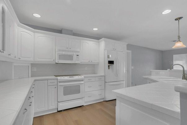 Interior, Kitchen, Pendant Lights, Recessed Lighting, Tile Countertops, Wood Texture Flooring