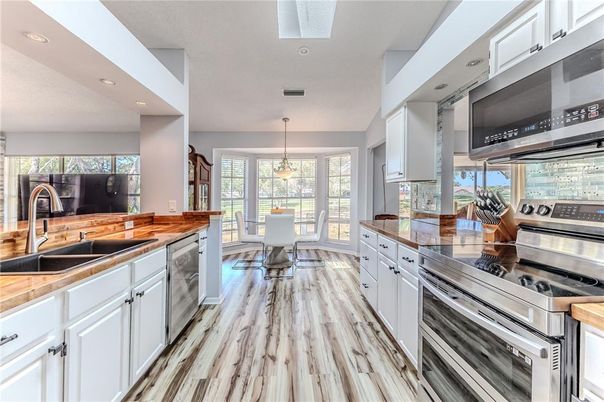 Dining room, Interior, Kitchen, Pendant Lights, Recessed Lighting, Stainless Steel Appliances, Wood Texture Flooring