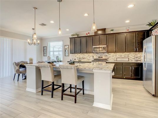 Chandelier, Dining room, Interior, Kitchen, Pendant Lights, Recessed Lighting, Stainless Steel Appliances, Wood Texture Flooring