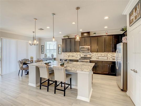Chandelier, Dining room, Interior, Kitchen, Pendant Lights, Recessed Lighting, Stainless Steel Appliances, Wood Texture Flooring