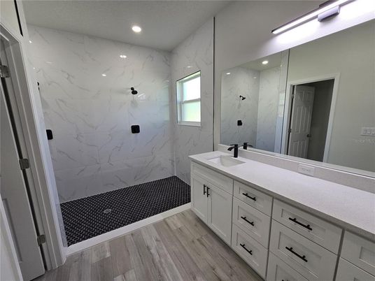 Bathroom, Dual Sink Vanities, Interior, Marble Walls, Recessed Lighting, Wood Texture Flooring