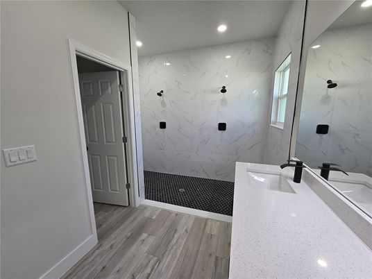 Bathroom, Glass Shower, Interior, Marble Walls, Recessed Lighting, Wood Texture Flooring