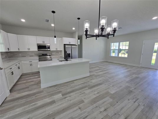 Chandelier, Interior, Kitchen, Pendant Lights, Recessed Lighting, Stainless Steel Appliances, Wood Texture Flooring