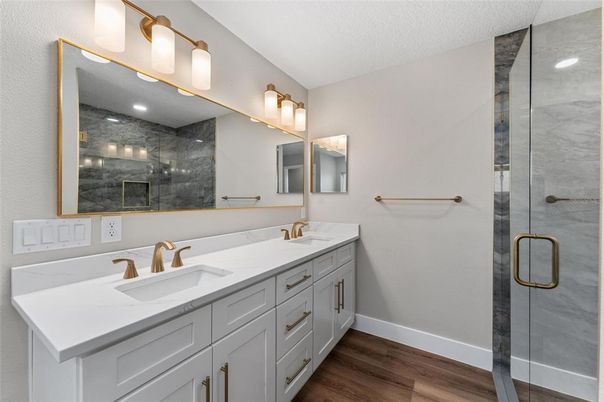 Bathroom, Dual Sink Vanities, Glass Shower, Interior, Marble Walls, Wood Texture Flooring